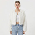 Front view of a model wearing a white cropped faux fur jacket.