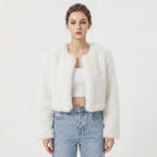 Front view of a model wearing a white cropped faux fur jacket.