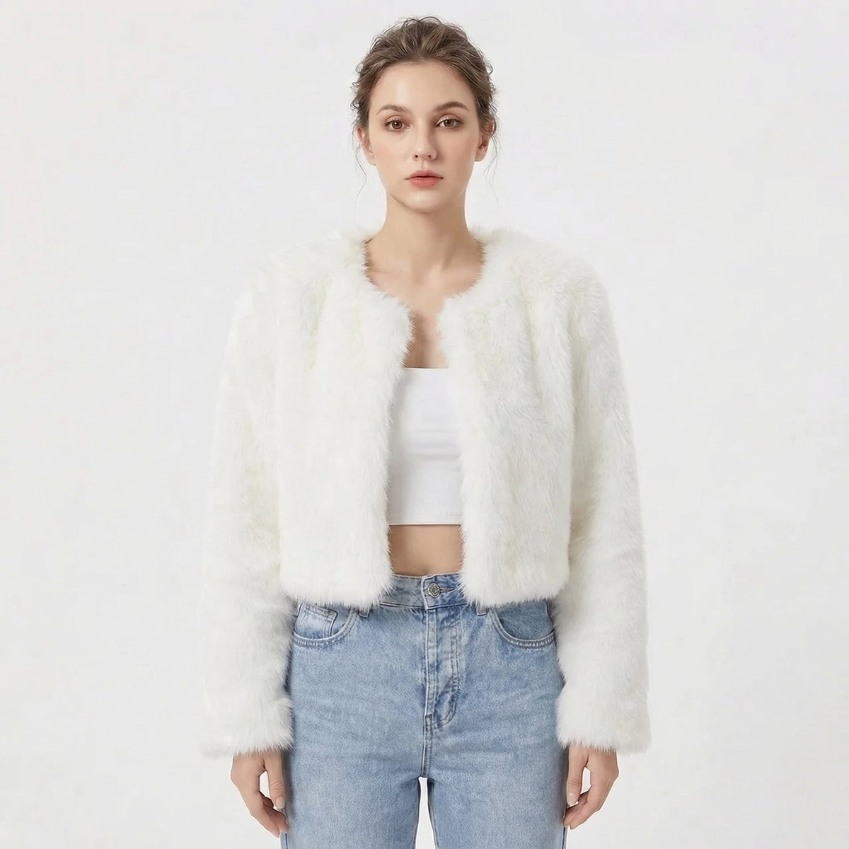 Front view of a model wearing a white cropped faux fur jacket.