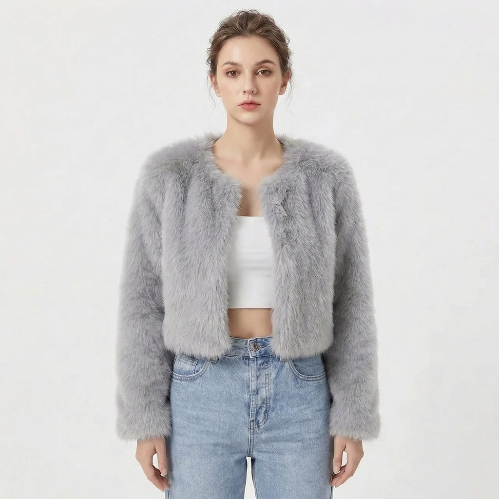 Front view of a model wearing a light grey cropped faux fur jacket.