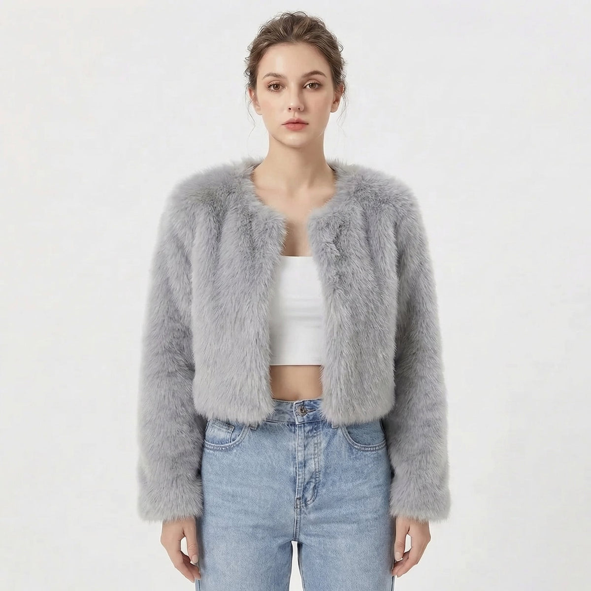 Front view of a model wearing a light grey cropped faux fur jacket.