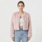 Front view of a model wearing a pink cropped faux fur jacket.