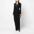 Front full-length studio shot of a model wearing a black double-breasted tuxedo maxi dress.