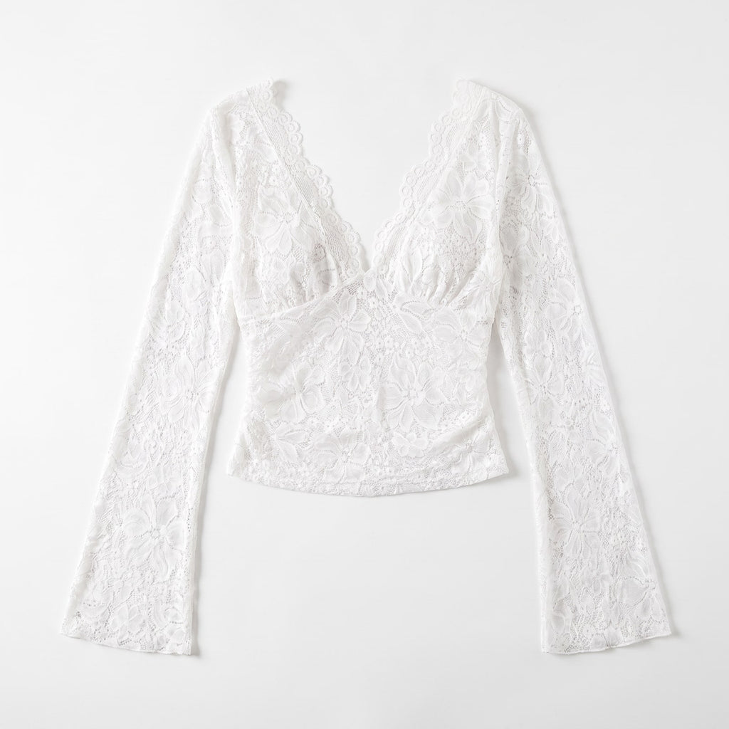 Flat lay front view of a white floral lace crop top with long bell sleeves.