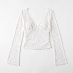 Flat lay front view of a white floral lace crop top with long bell sleeves.