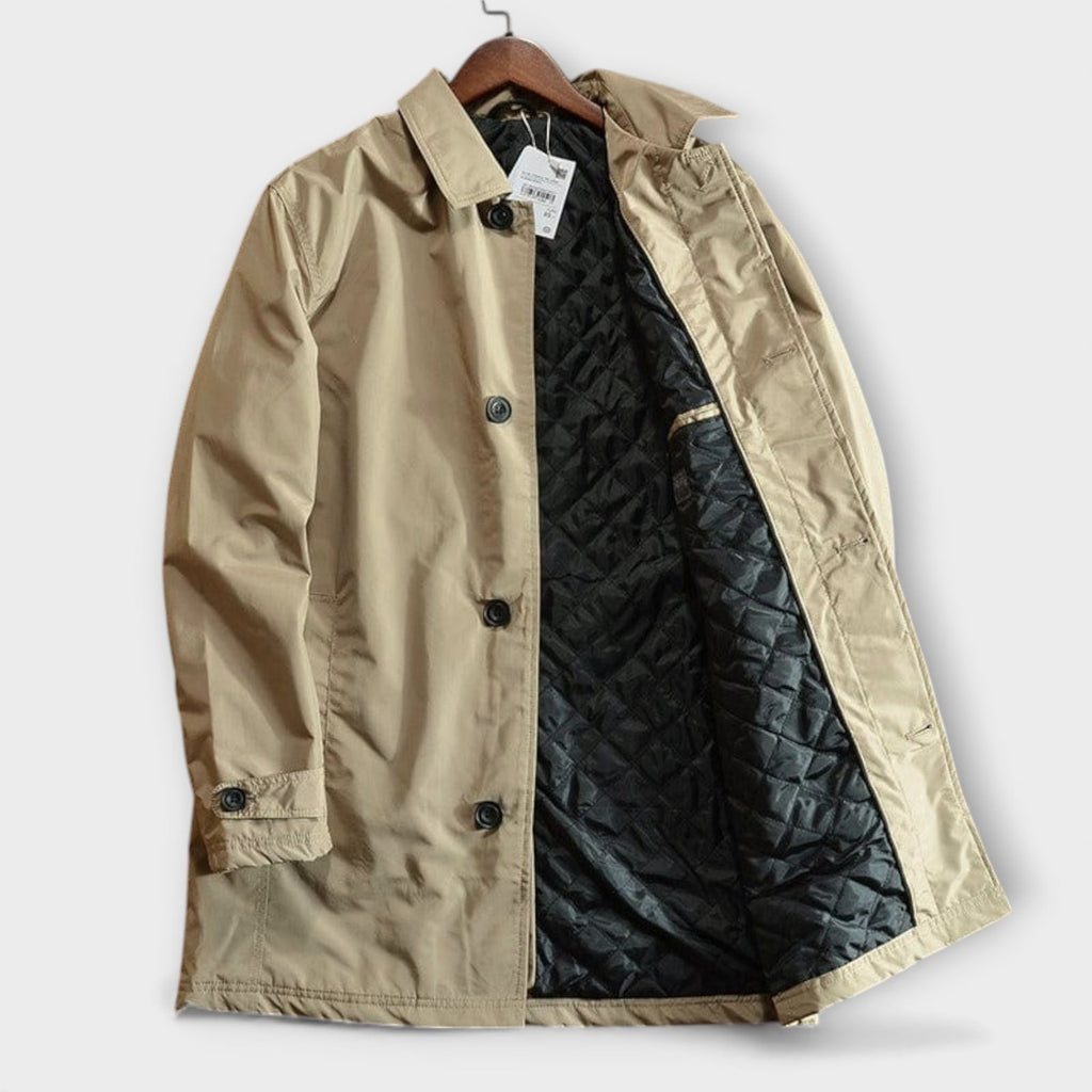 A front view of the open beige trench coat displaying its black quilted interior.