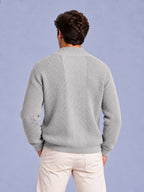 Back view of a man wearing a light grey waffle knit shawl collar cardigan.