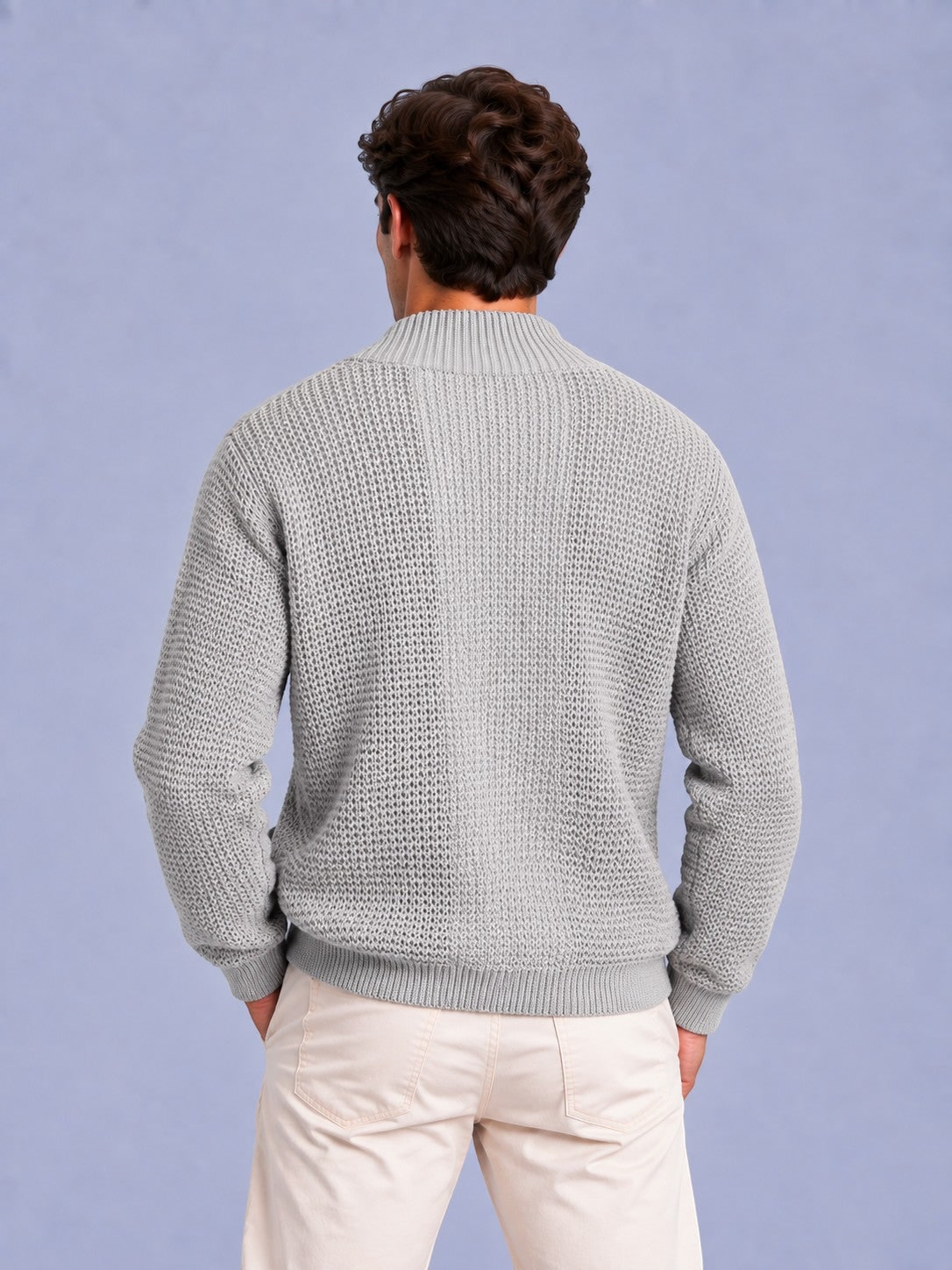 Back view of a man wearing a light grey waffle knit shawl collar cardigan.