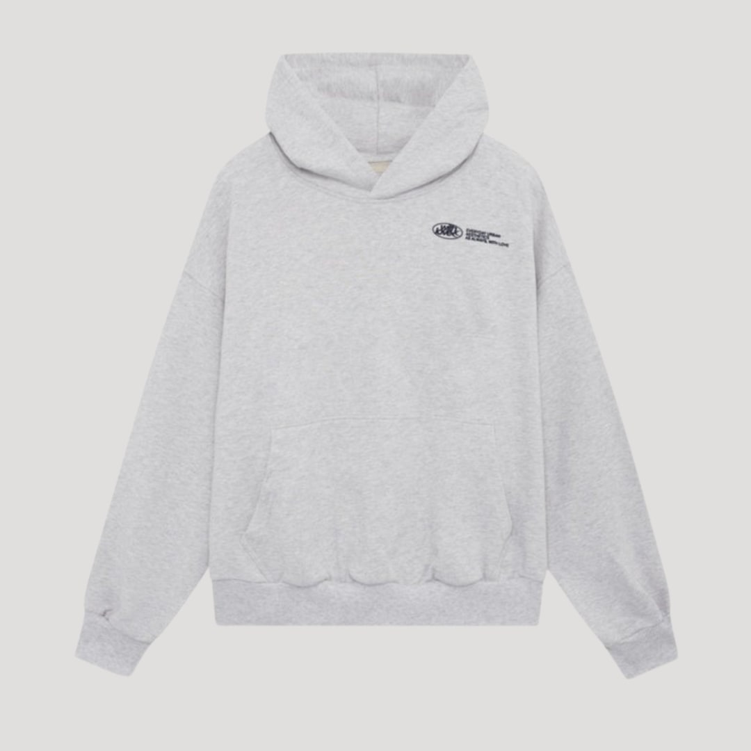 Front view of a light grey oversized pullover hoodie with a dark graphic print on the chest.