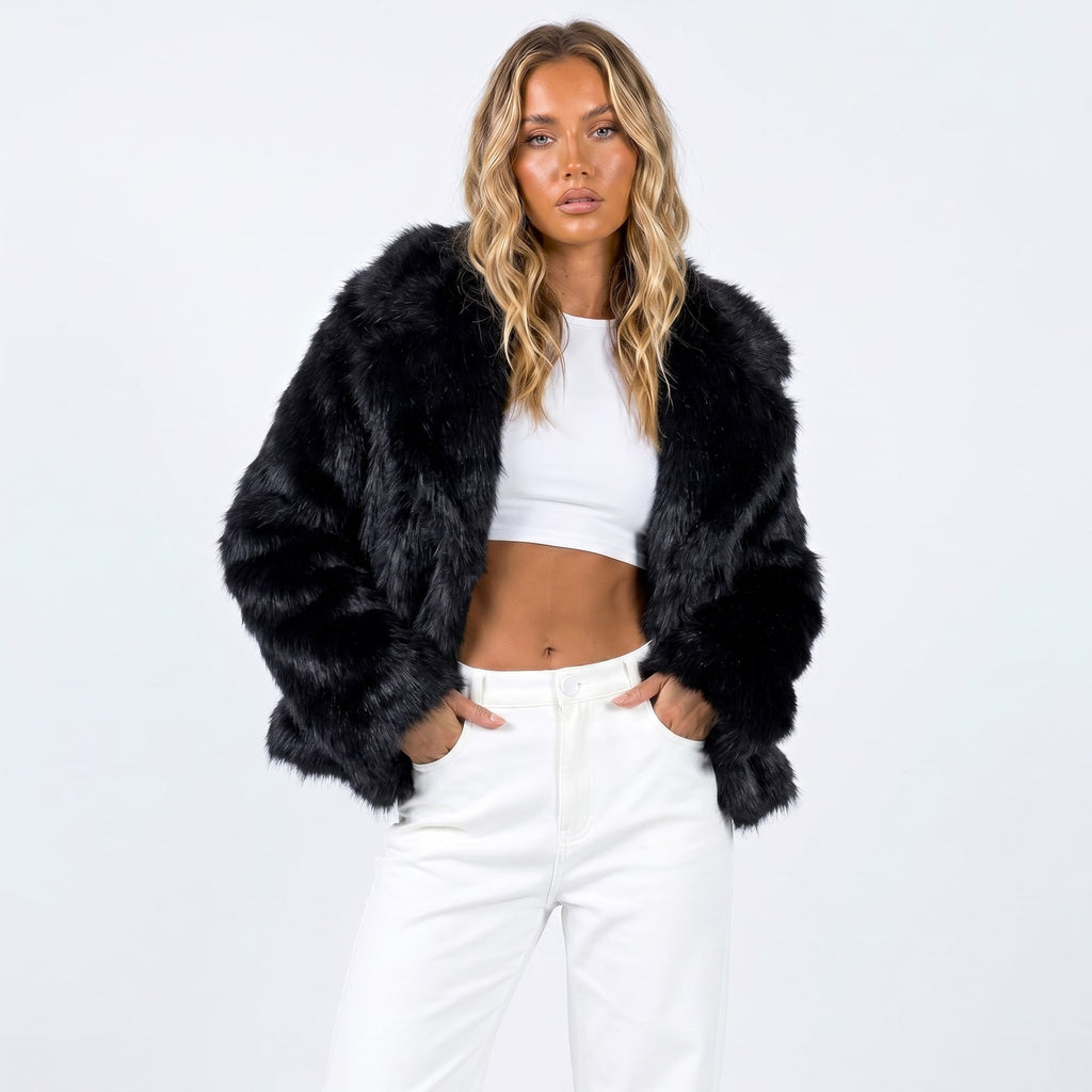Front view of a woman wearing a black faux fur jacket over a white crop top and white pants.