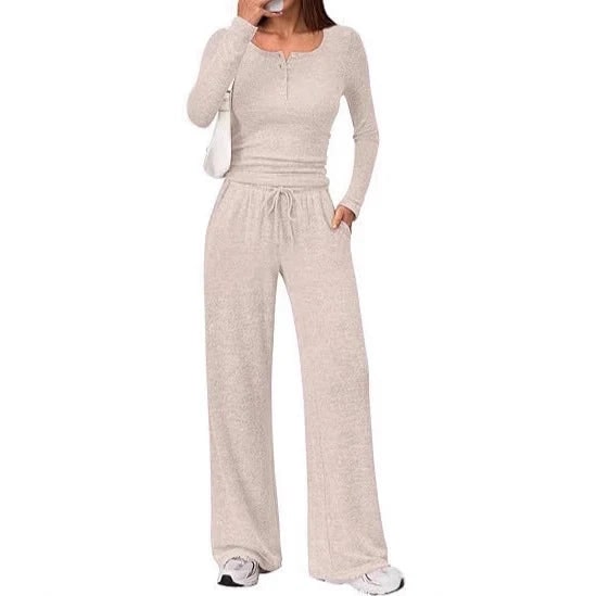 Front view of a woman wearing a beige ribbed long sleeve henley top and matching wide-leg lounge pants.