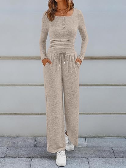 Full body front view of a woman wearing a beige ribbed long sleeve henley top and matching wide-leg lounge pants outdoors.