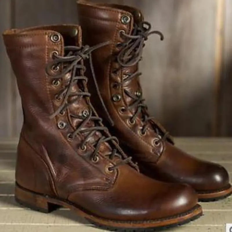 A front view of the pair of brown leather lace-up boots, both standing upright with laces tied.