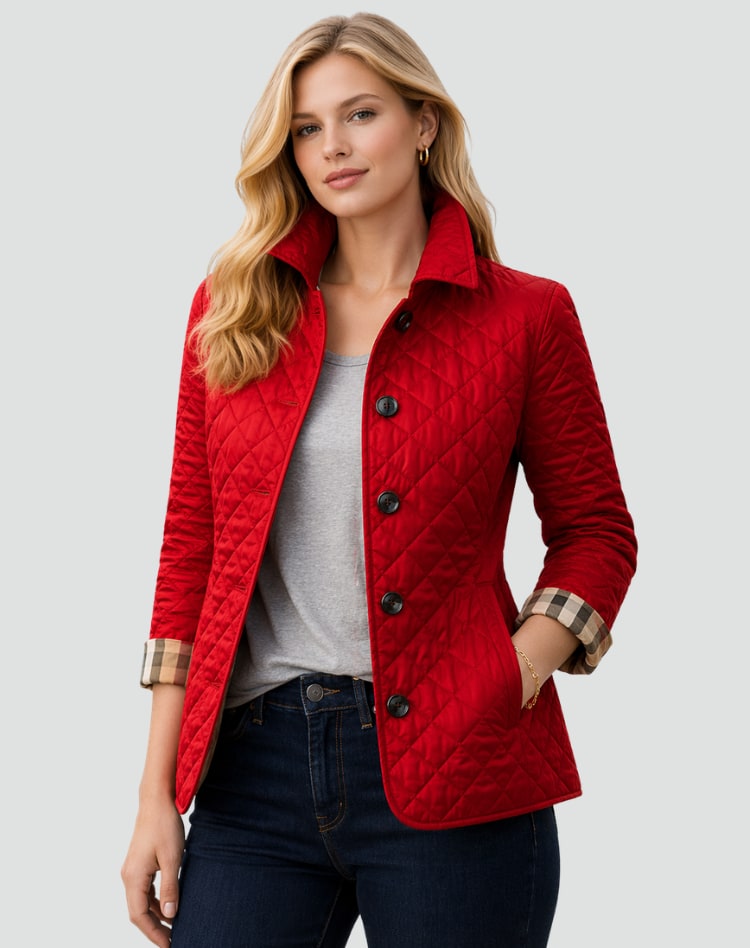 Front view of a woman wearing a red diamond quilted jacket over a grey t-shirt, with plaid-lined cuffs rolled.
